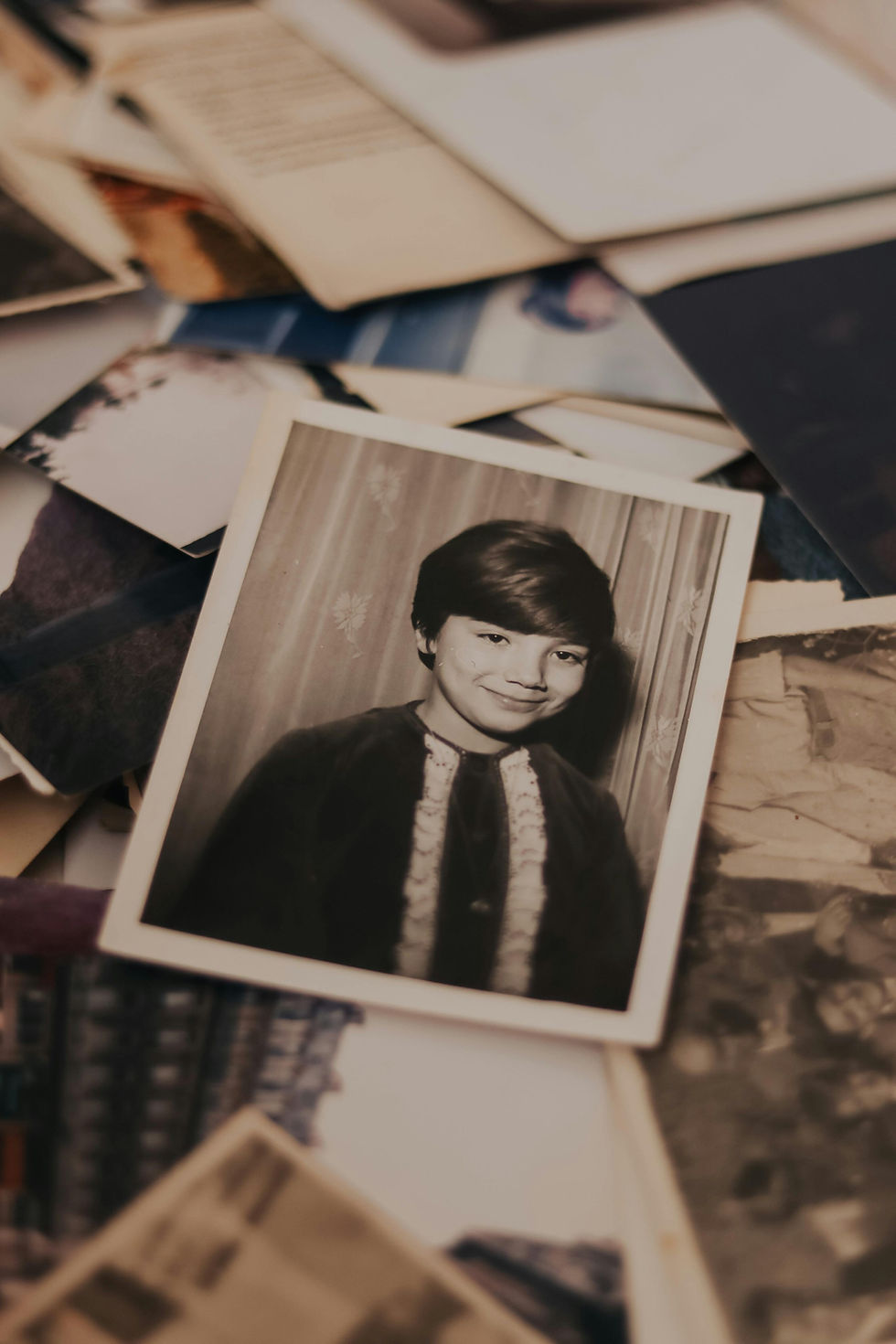 Old black and white childhood photograph among scattered memories