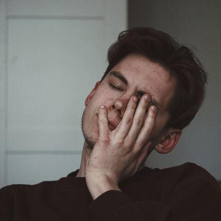 Person sitting alone, exhausted from constantly putting others' needs before their ownPerson sitting alone, exhausted from constantly putting others' needs before their own