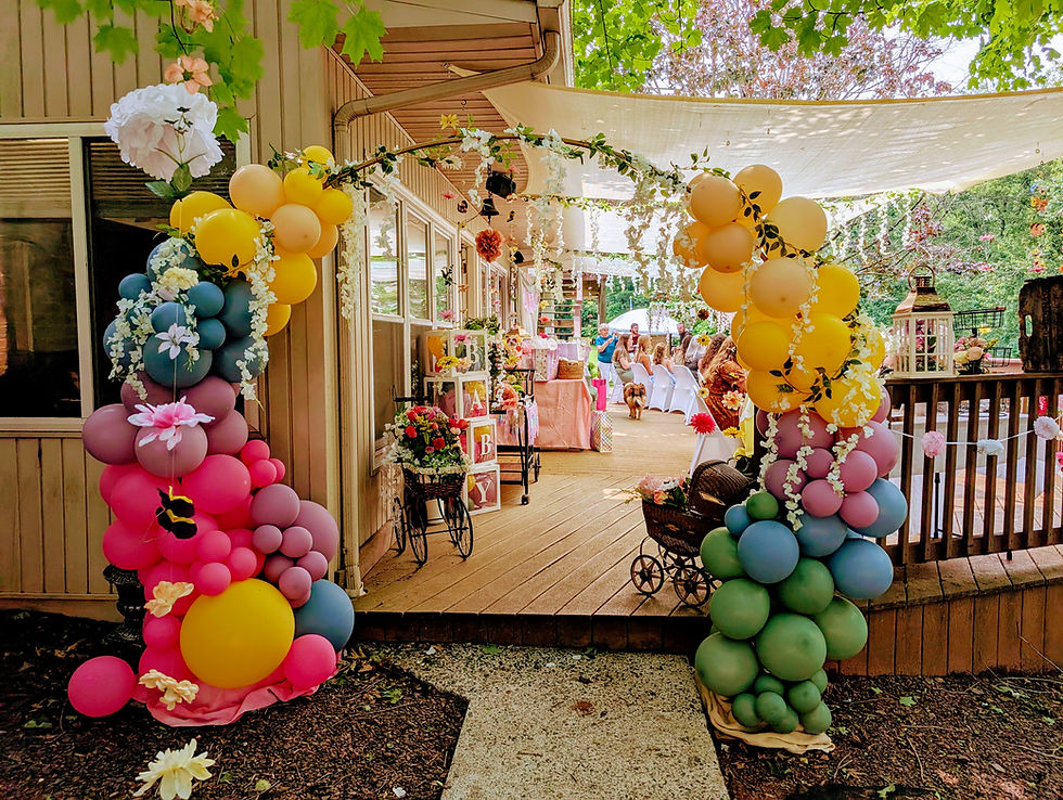 colorful balloon arch entrance to a garden party
