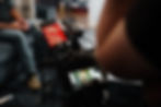 A man's elbow next to a video camera 