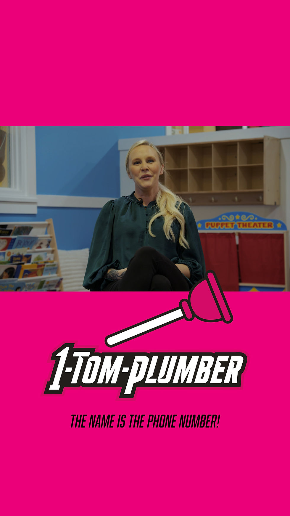 A blonde woman with a black shirt on a pink background