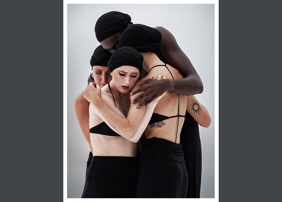 Group of dancers embracing.