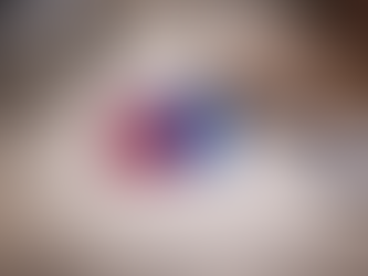 Ruby and sapphire gemstones on a jeweller’s workbench with loupe, caliper, and wooden bench pin, representing artisan craftsmanship and gemstone evaluation