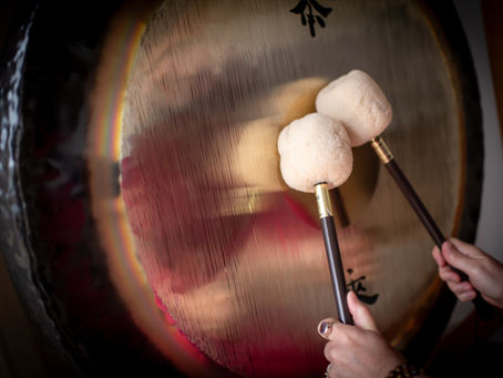 woman hands playing a gong sound healing 