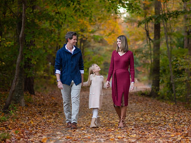 Family walking in the forest during Fall