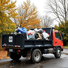 black dump truck with trash inside .jpg