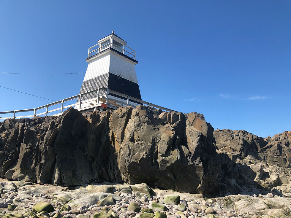 The lighthouse perched on the rocky shore in Margaretsville, Nova Scotia.