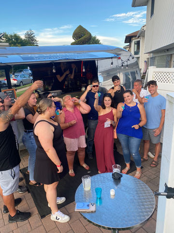 uests enjoying a private party with StarBar NY's luxury mobile bar service.