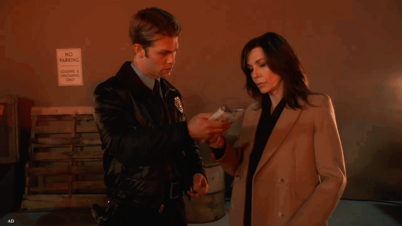 Anna and Dex discussing evidence during the aftermath of an explosion