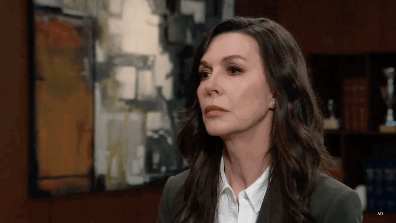 Anna exasperated in her office, raises and drops her arms