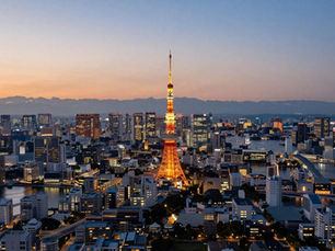 Aerial view of Tokyo Bay at dusk showing Japanese coastal skyline with illuminated skyscrapers and strategic harbor waters against twilight horizon, Indo-Pacific security perspective 2026