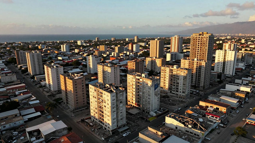 Aerial drone view of earthquake devastation in La Guaira, Venezuela, June-July 2026, showing collapsed residential buildings with Venezuelan military personnel and civilian volunteers conducting search and rescue operations after twin 7.2 and 7.5 magnitude earthquakes that killed over 5,000 people.