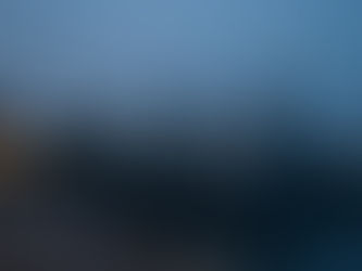 Cartel risk visual: grey patrol vessels moored at a Caribbean harbour at dusk, amber dock lights on steel-blue water.