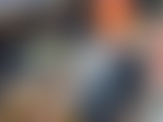 Man standing at a construction site with workers below.