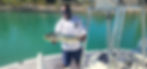 Man on a boat holding a Mahi-Mahi fish