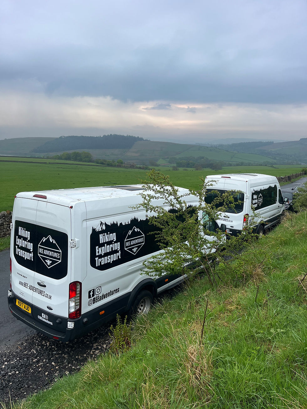 Wide angle view of a Bee Adventures vehicle parked near a Lancashire peak