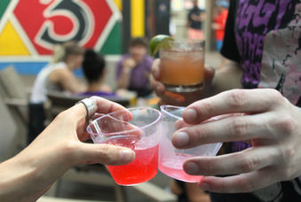 Two hands clinking glasses