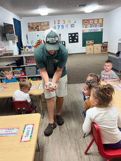 The zoo visits our Clubhouse class and shows the kids a turtle.