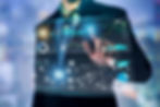 Person interacting with digital HUD displaying AI data, graphs, and maps. Blue and green visuals with futuristic tech ambiance.
