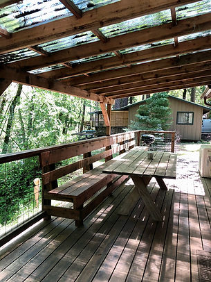 Eat on the deck overlooking the creek at Maple - Cabin 4 at Pine Grove in Cobb, California