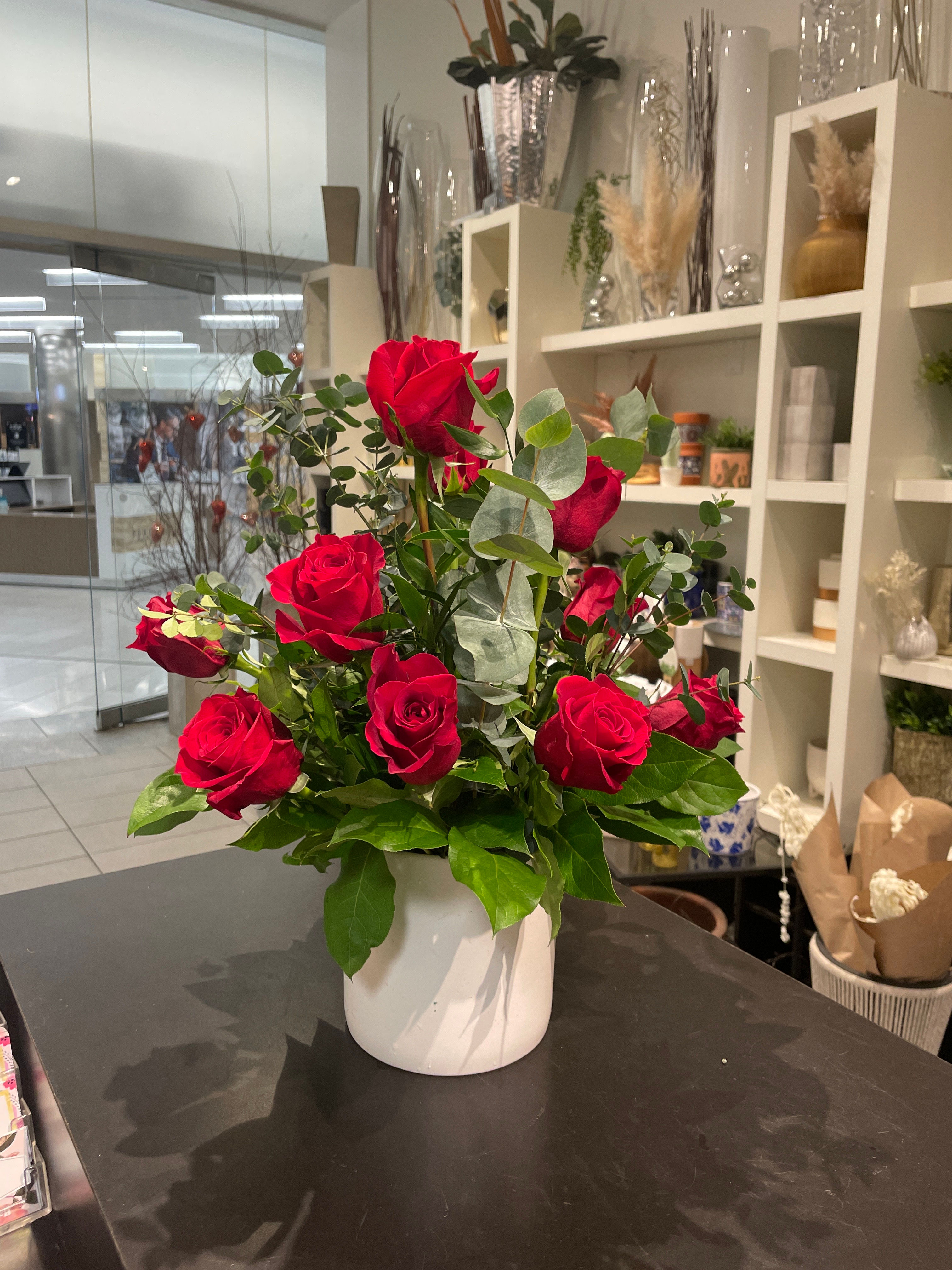 Dozen red roses in ceramic vase