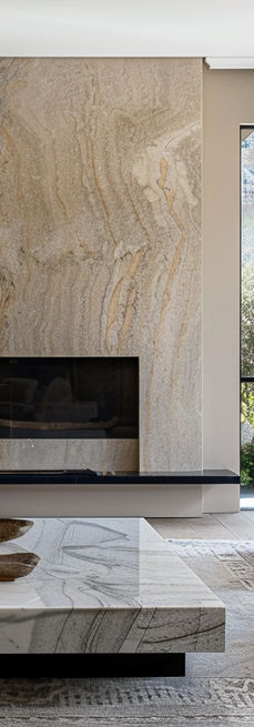 Stylish modern lounge area featuring a sleek marble fireplace, offering breathtaking views of the Cape Winelands. This sophisticated space combines luxury and comfort, making it perfect for relaxation and entertaining. Ideal for those seeking inspiration for contemporary interiors that highlight stunning landscapes and elegant design elements.