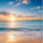 Ocean waves rolling onto a sandy beach during sunrise.