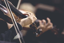 The girl's hand on the strings of a violin