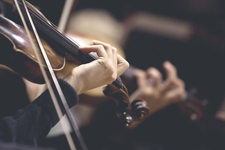 The girl's hand on the strings of a violin
