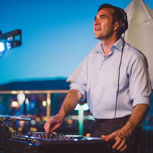 DJ John Byrne elevating the wedding atmosphere with his music, set against a backdrop of breathtaking hills, creating a harmonious blend of celebration and natural beauty.