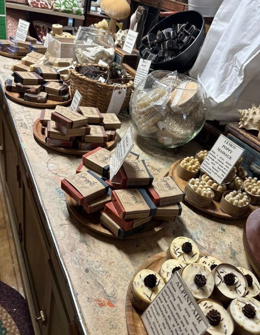 Spriggits display at libby's antiques shows wide variety of soaps on wooden displays across a long flat surface