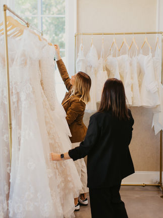 Bride shopping with stylist at Senoia Bridal, exploring wedding gown options together in the boutique