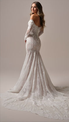 Maggie Sottero long-sleeve lace wedding dress with detailed cathedral train, available at Senoia Bridal