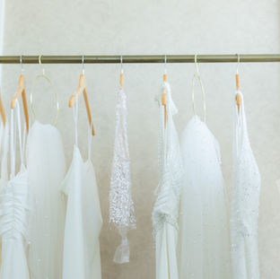 couture wedding dresses hanging on a rack