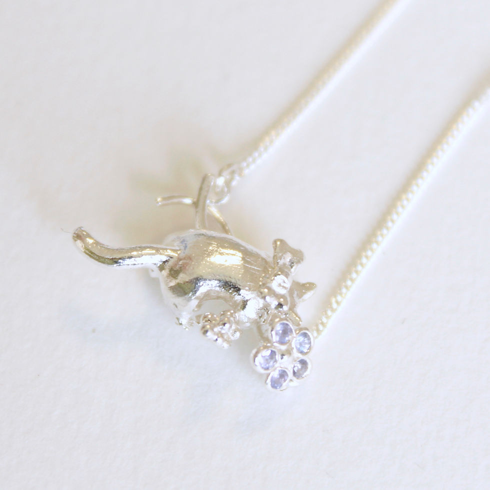 Thumbnail: Nobody's - the cat, with Tanzanite bloom