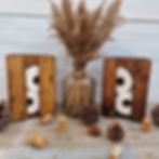 Wooden toilet roll holder made from reclaimed pallet wood, photographed against a clean white background