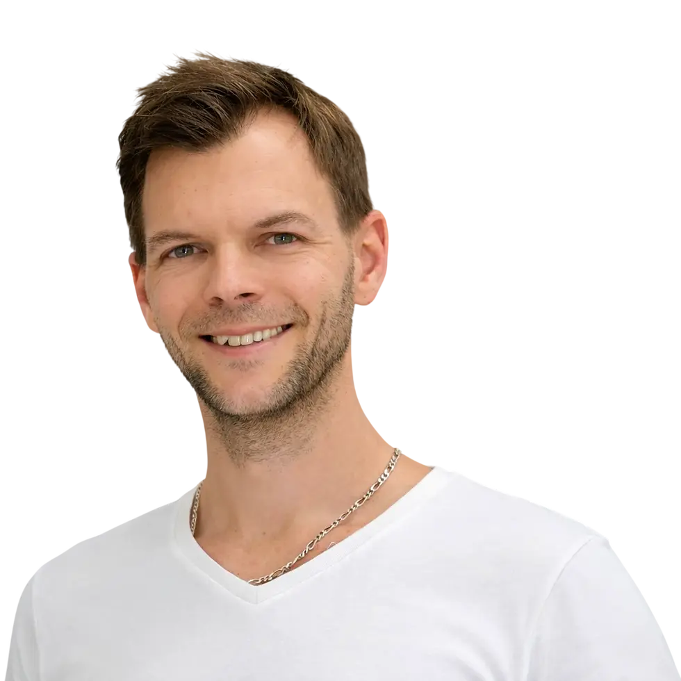 Studio photography of a smiling man with short brown hair and a beard, looking friendly and approachable.