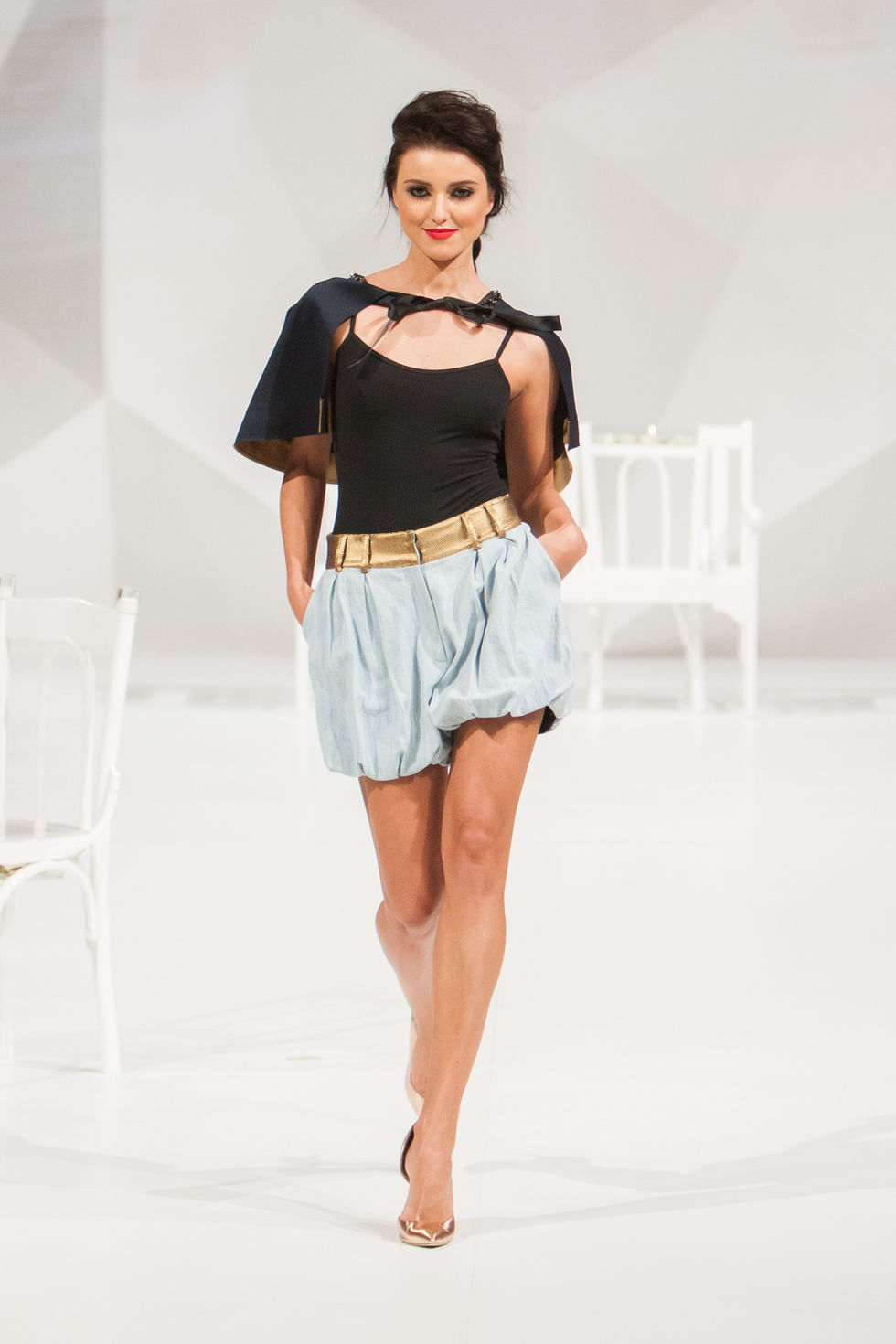 Model showcasing stylish black top and shorts