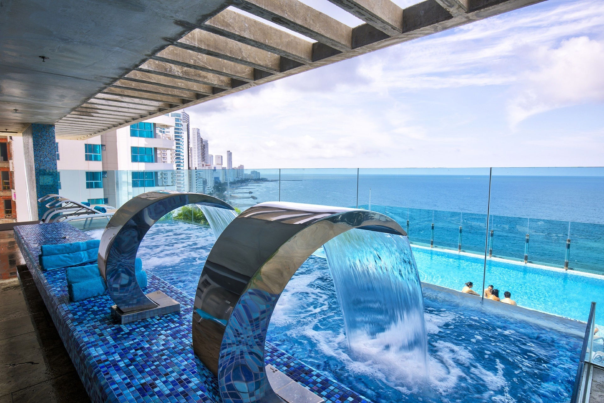 Rooftop pool at Estelar Cartagena de Indias Hotel overlooking a beautiful sunset over the Caribbean Sea in Cartagena