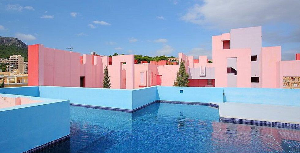 Close-up of contrasting blue and pink walls inside La Muralla Roja, adding a dreamy vibe to this iconic Instagrammable location.