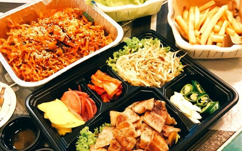 a serving of ramen, alongside a full set of cut toasts with a side of fries