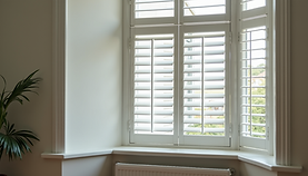 Close-up detail plantation shutter louvers and frame.