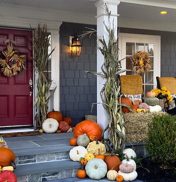 Pumpkins and corn stalks by The Autumn Charm Company.