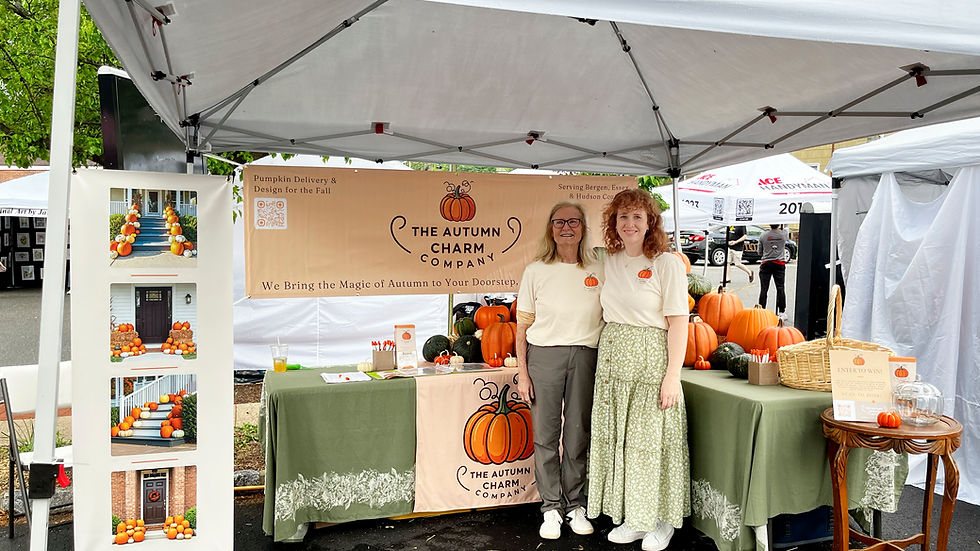 Owners of The Autumn Charm Company in front of their promotional booth at the 2025 Walnut St Fair