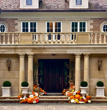 Fall porch decorating service display at a luxury home.