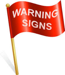 A picture depicting a red flag and words - warning signs