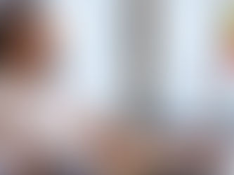 A lady looking pleasantly at an IV bag drip