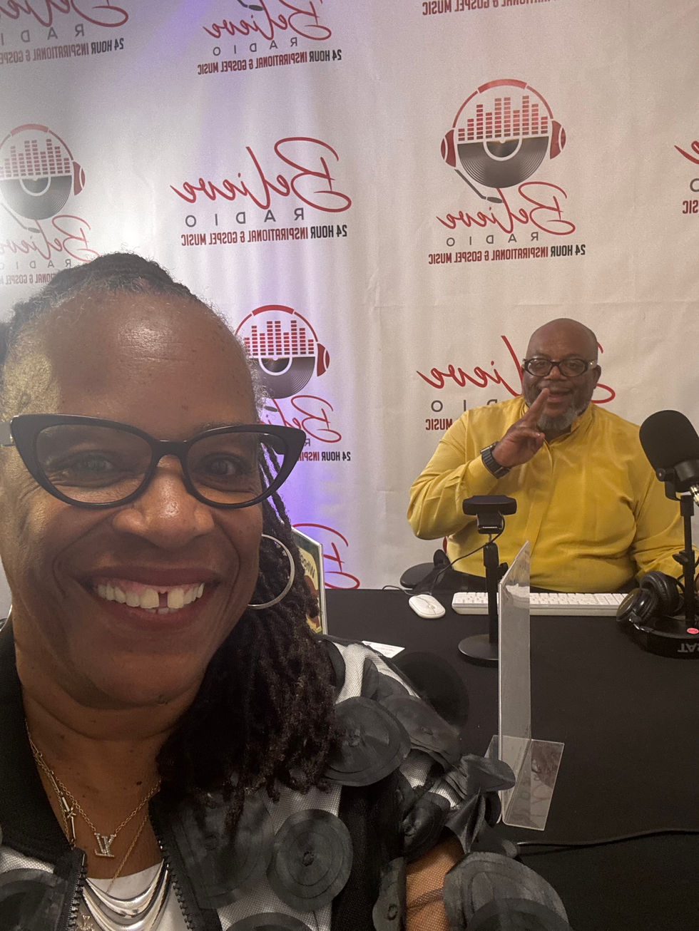 Woman takes selfie with man at B-Rima Radio studio.