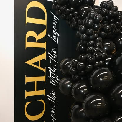 Black and gold sign "CHARD man the Myth the Legend" with balloons.