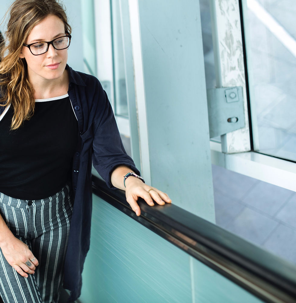 Lady touching an escalator handrail
